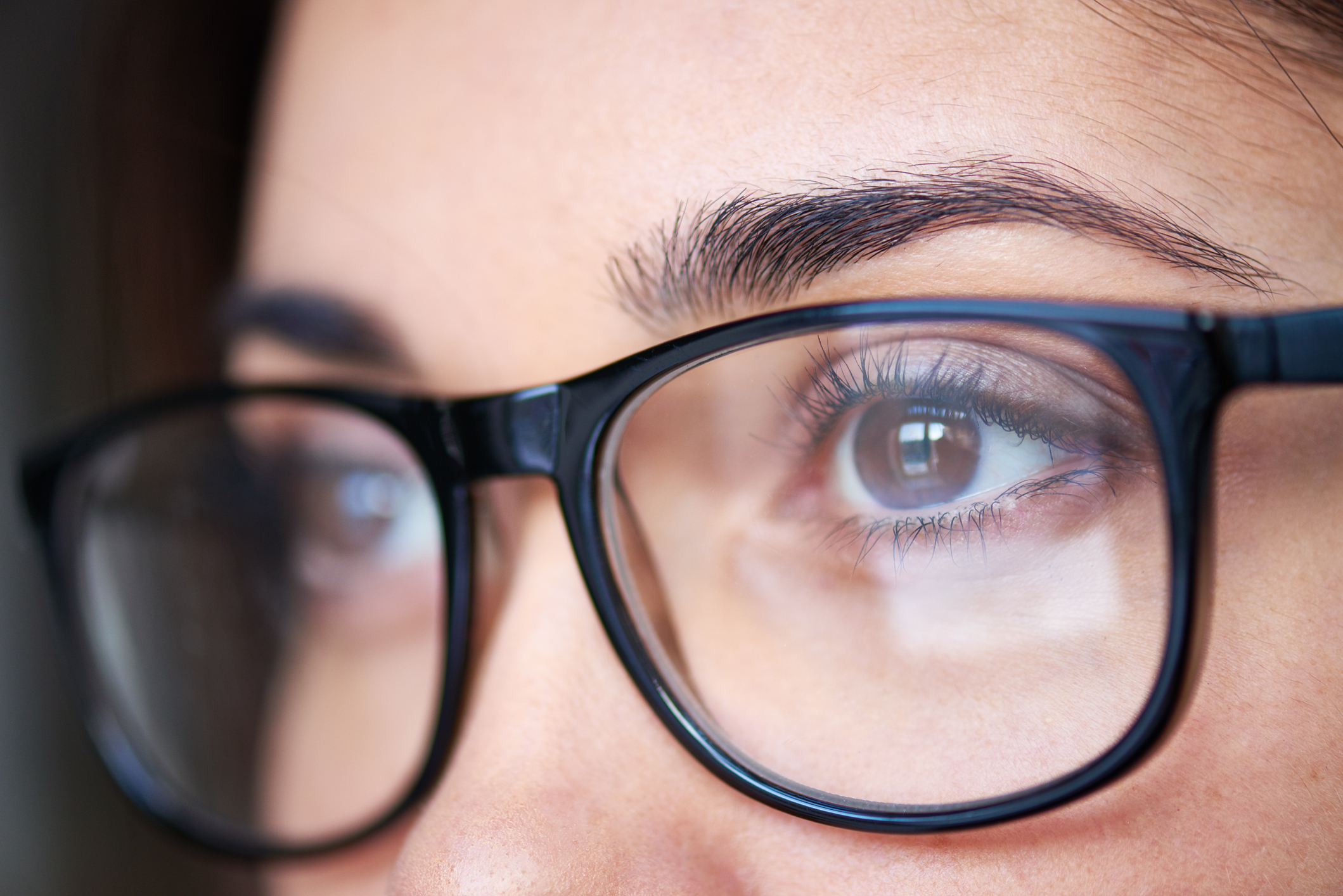 A closeup of a female's eyes in glasses
