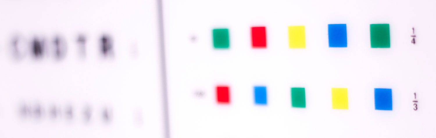 Slightly out of focus color blind eye test chart with red, green, yellow, and blue squares.