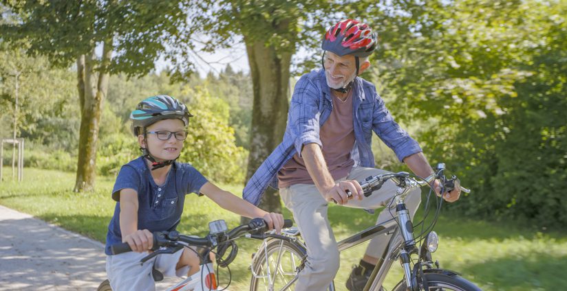 Grandfather and grandson riding bicycles