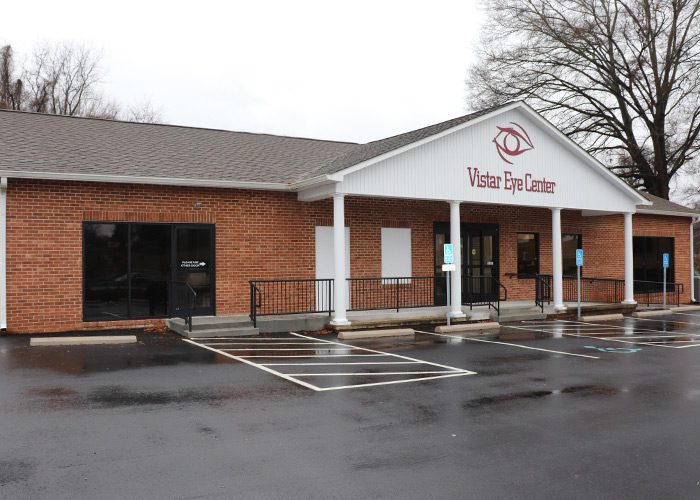 An exterior view of brick Vistar Eye Center building and parking lot in Martinsville.