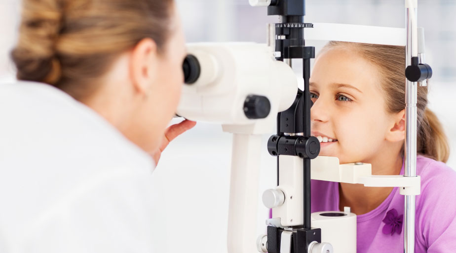 A child having their eye examined by an eye doctor