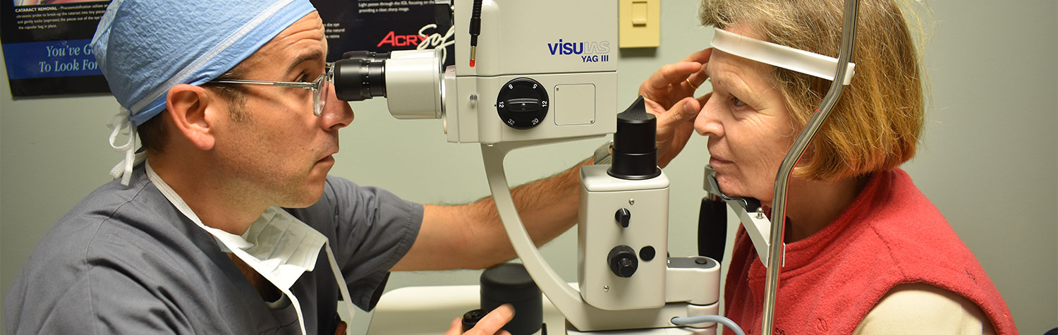 An eye doctor examining a patient using a medical device