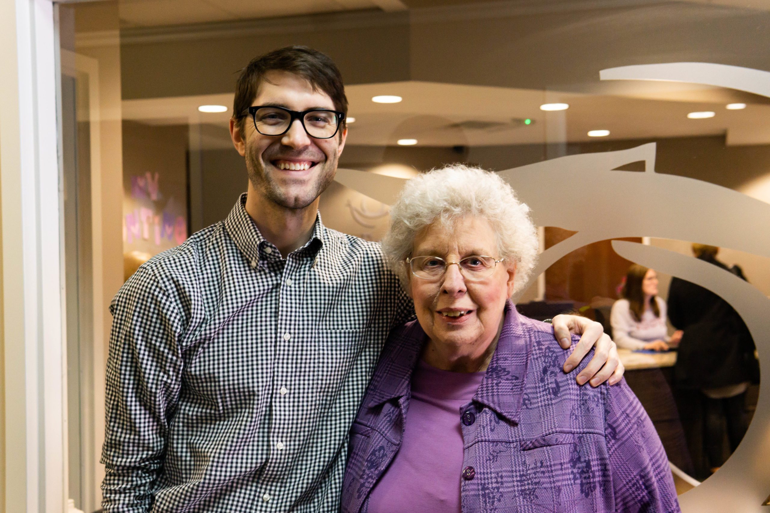 Dr. Schoedel posing for a picture with an older, female patient