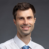 Vistar Eye Center's Dr. Bryan Strelow smiling in front of a gray background.