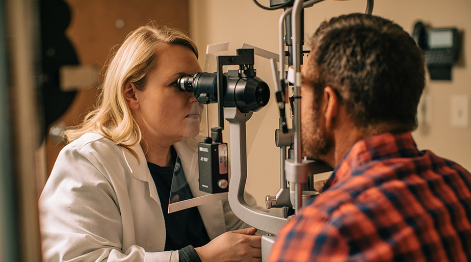Dr. Andrews with a patient during an eye exam.