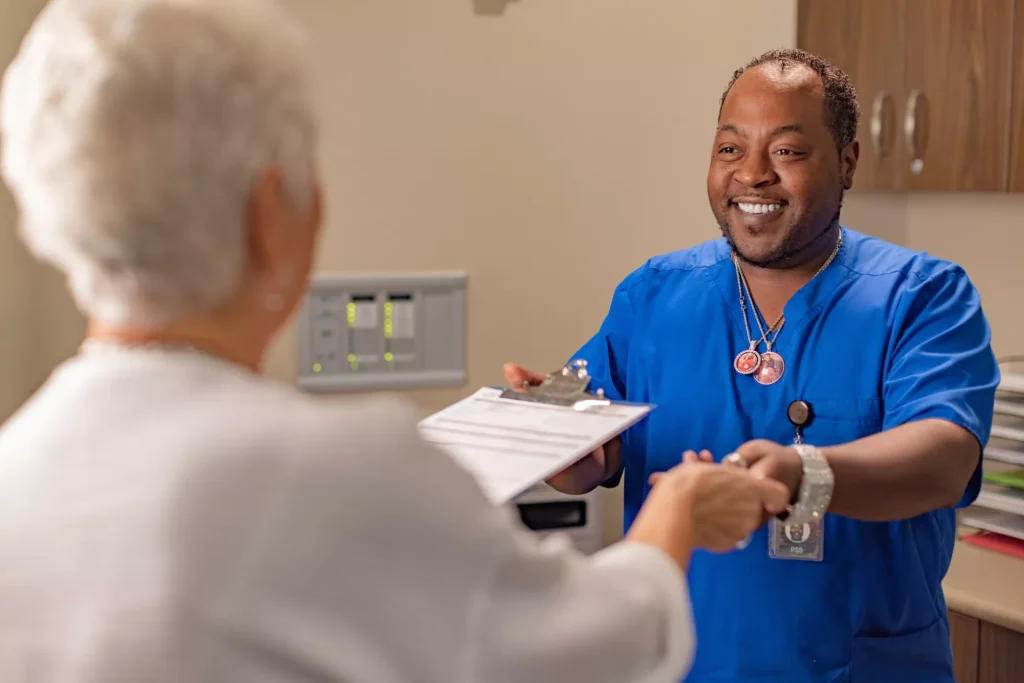 Patient service specialist assisting a Vistar patient with paperwork